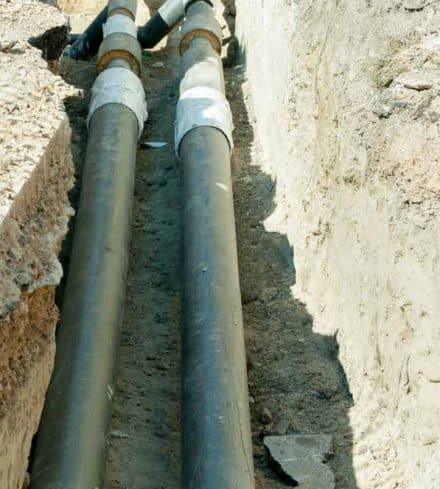 pipes in the ground exposed for smart water technology services