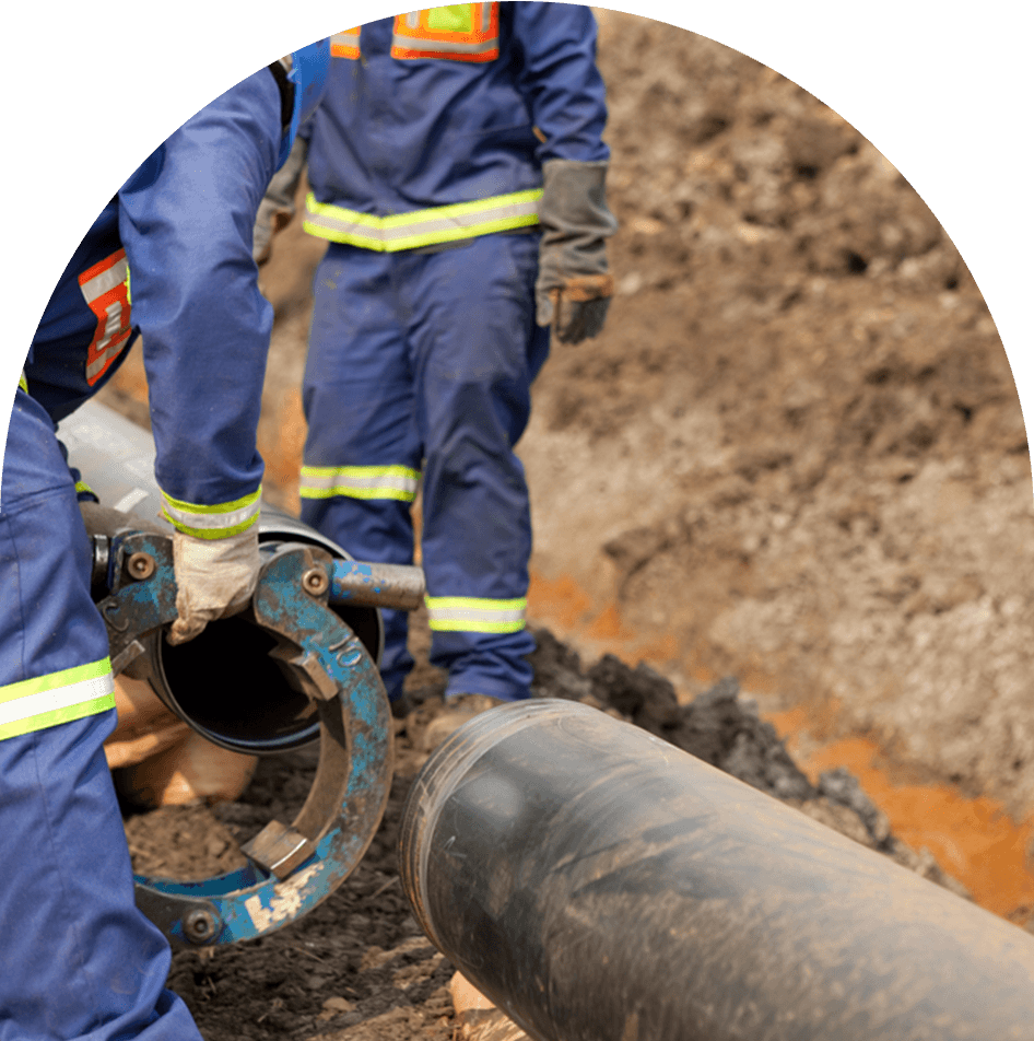 Workers wearing protective high visibility clothing fixing and joining industrial pipes — Blog in Burleigh Heads, QLD