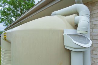 Rainwater running off roof into rainwater tank — NRW Consulting in Burleigh Heads, QLD