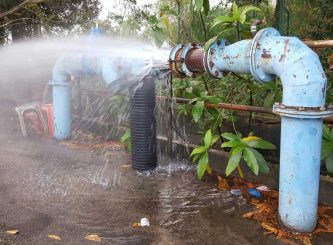 Rusty burst pipe spraying water due to failure of joint restraint — Water Management Near Me in NSW