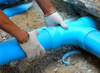 Workers are water pipes with PVC joints Elbow — Water Management Near Me in NT
