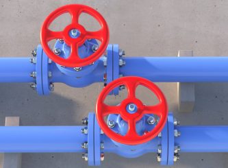 Industrial metal pipelines blue color and valves with red wheels on concrete wall — Water Management Near Me in WA