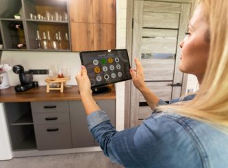 Woman holding smart tablet with app smart home — Water Management in Burleigh Heads, QLD